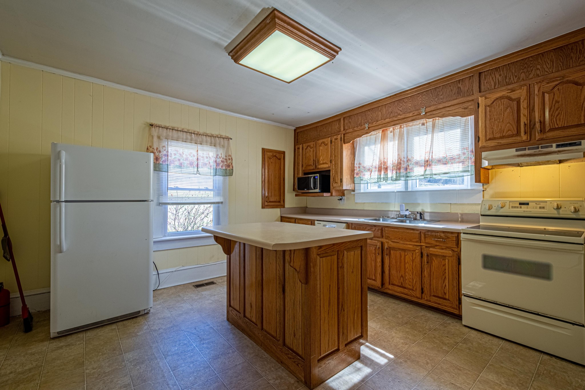 9263 Bethel Road Prospect, TN 38477 - Photo 12 of 45 a kitchen with stainless steel appliances granite countertop a refrigerator a sink dishwasher a stove and white countertops with wooden floor