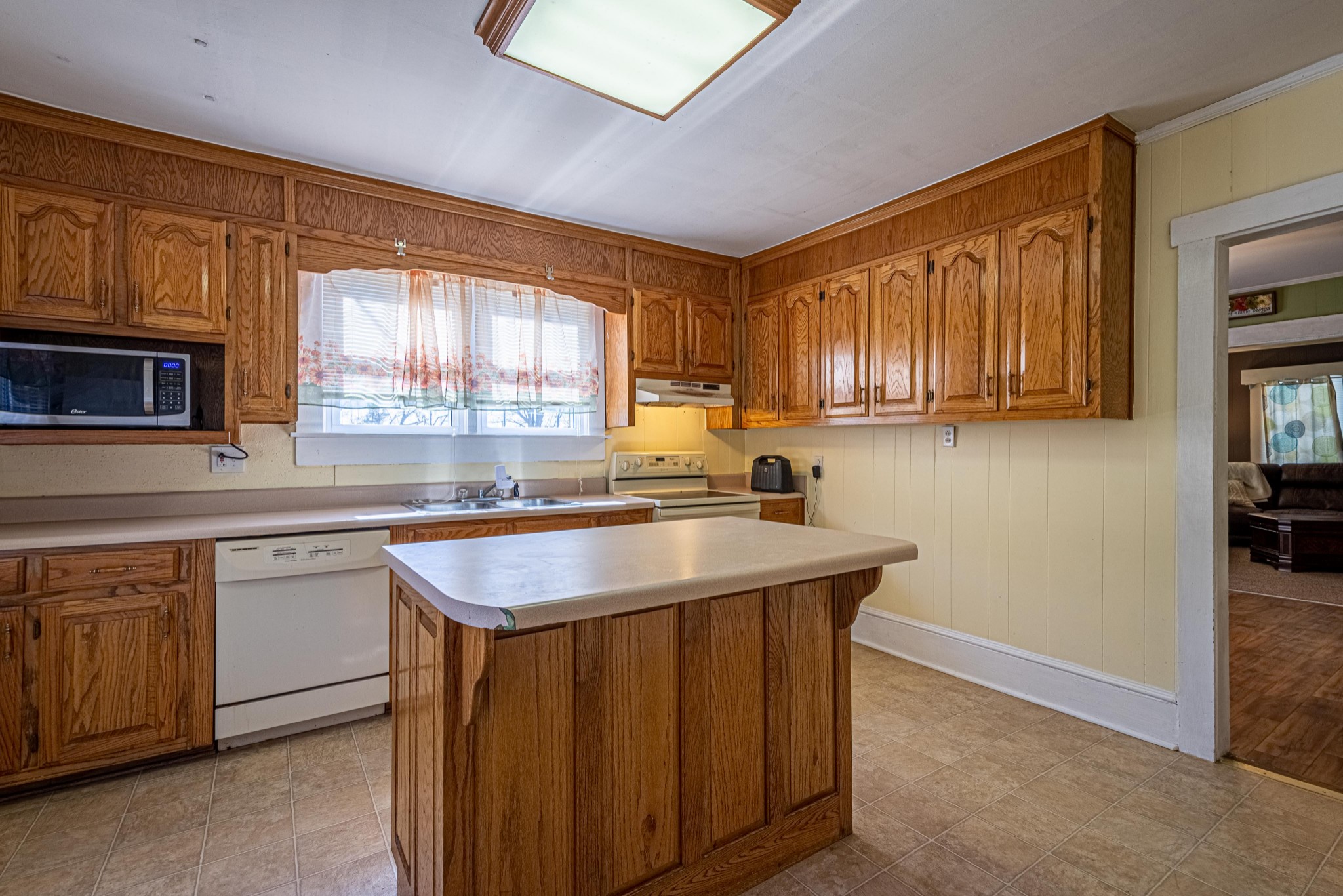 9263 Bethel Road Prospect, TN 38477 - Photo 14 of 45 a kitchen with stainless steel appliances granite countertop wooden cabinets a sink and a window