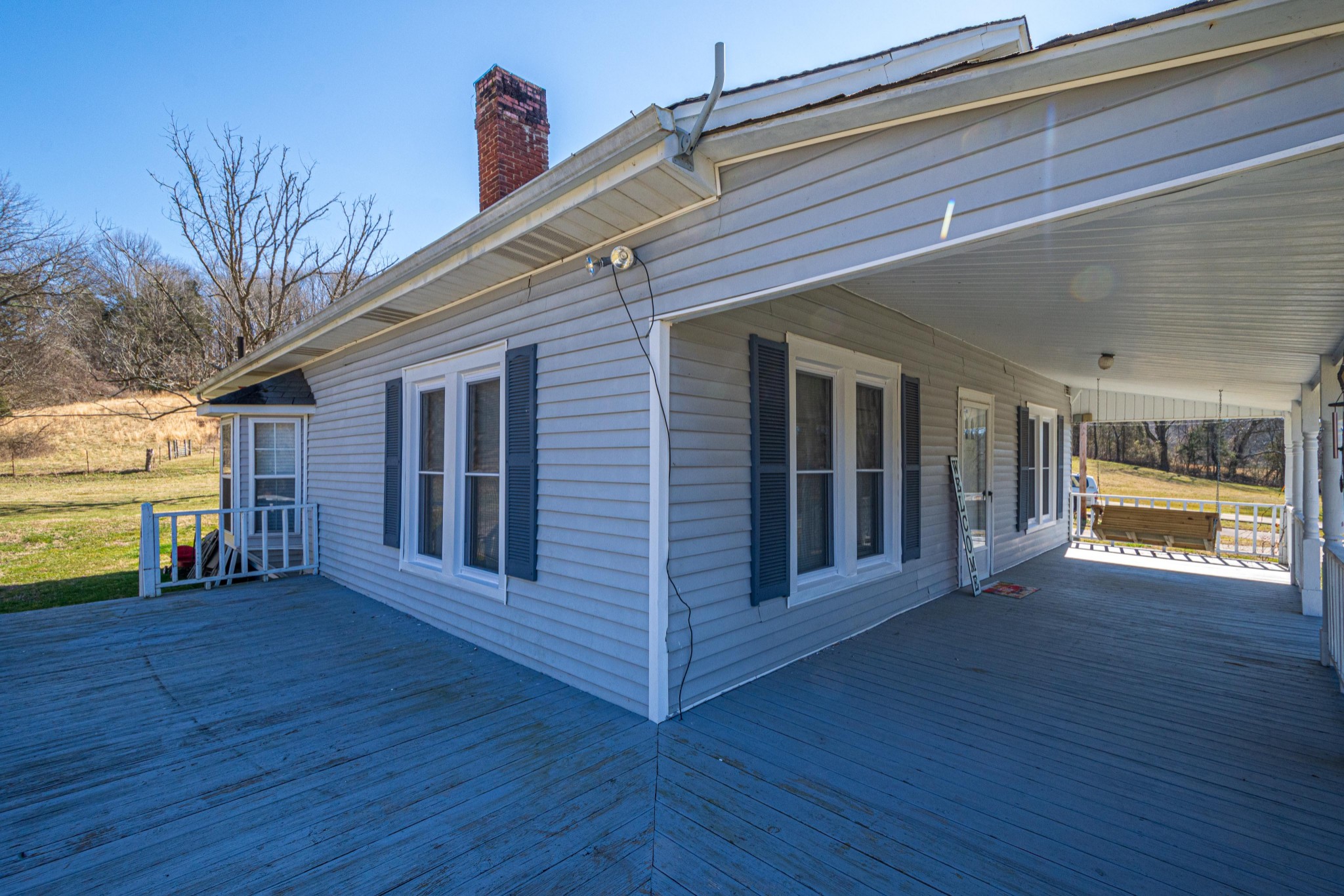 9263 Bethel Road Prospect, TN 38477 - Photo 38 of 45 a view of a house with wooden deck and a floor to ceiling window