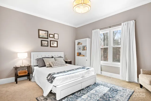 a bedroom with a large bed and a window