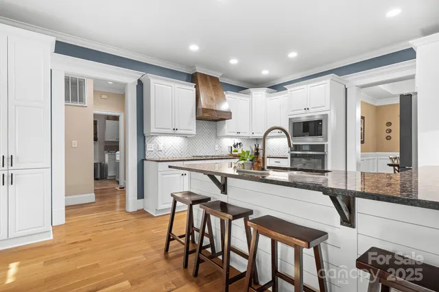 a kitchen with kitchen island granite countertop wooden cabinets and center island