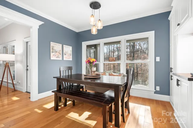 a view of a dining room with furniture window and wooden floor