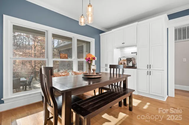 a view of a dining room with furniture window and wooden floor