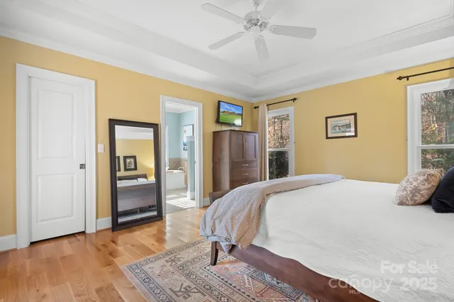 a bedroom with a bed and a chandelier