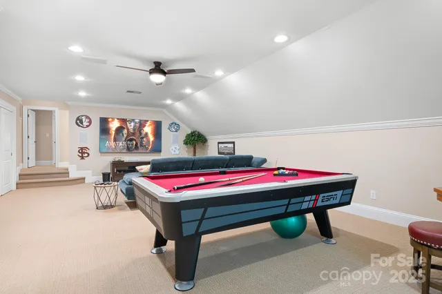 a room with pool table and windows
