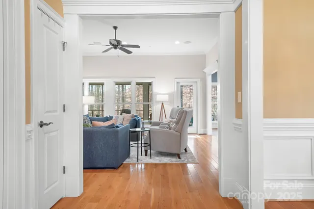 a living room with furniture and a chandelier