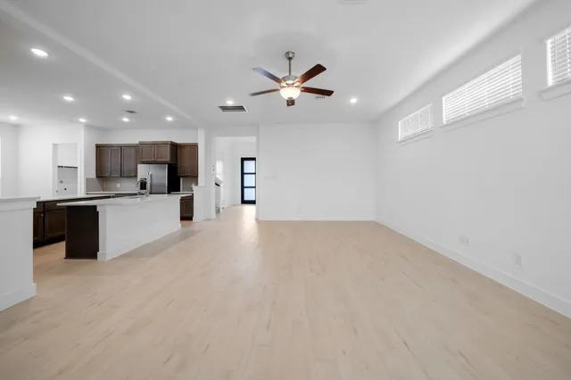 a view of a kitchen with a sink and a refrigerator