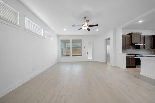 a view of a kitchen with an empty space and a window