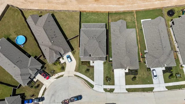 an aerial view of a house with a yard