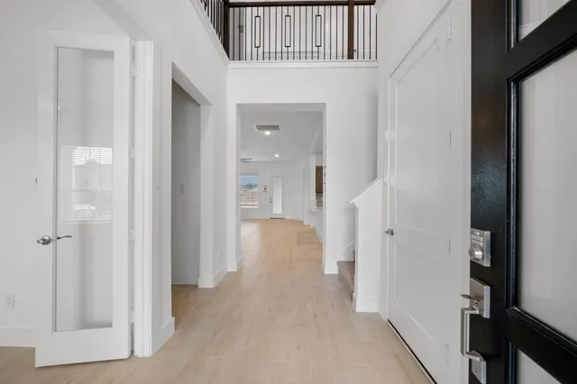 a view of a livingroom with wooden floor and staircase