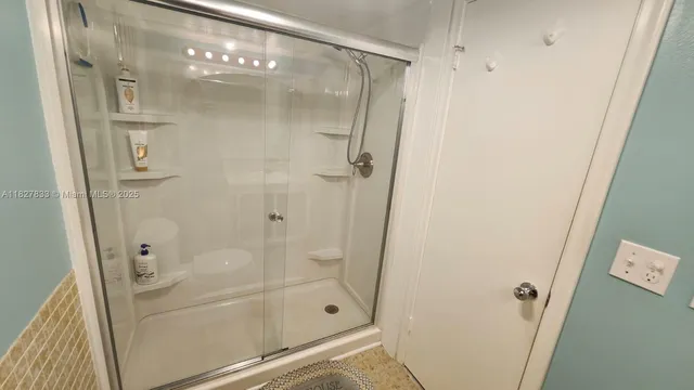 a spacious bathroom with a toilet a sink and mirror