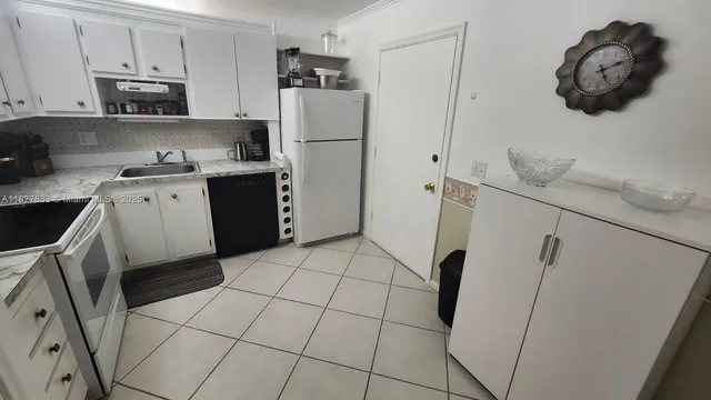 a kitchen with a stove a sink and a refrigerator