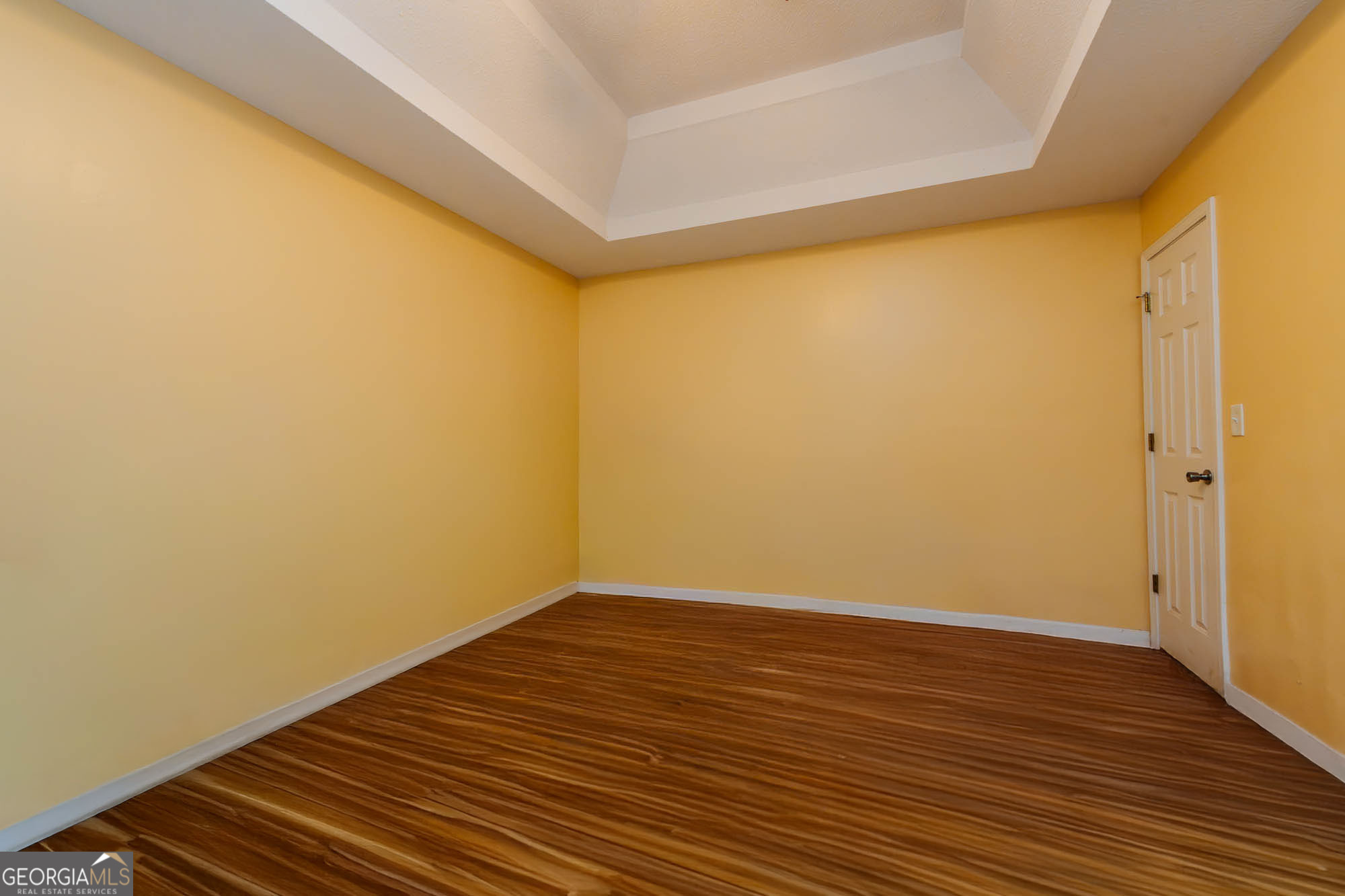 525 Hardison Church Road Byron, GA 31008 - Photo 7 of 32 a view of an empty room with wooden floor and a window