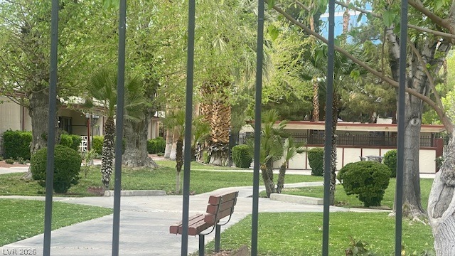 350 East Desert Inn Road, Unit B103 Las Vegas, NV 89109 - Photo 12 of 22 A tranquil green space with mature trees and pathways offers a serene retreat.