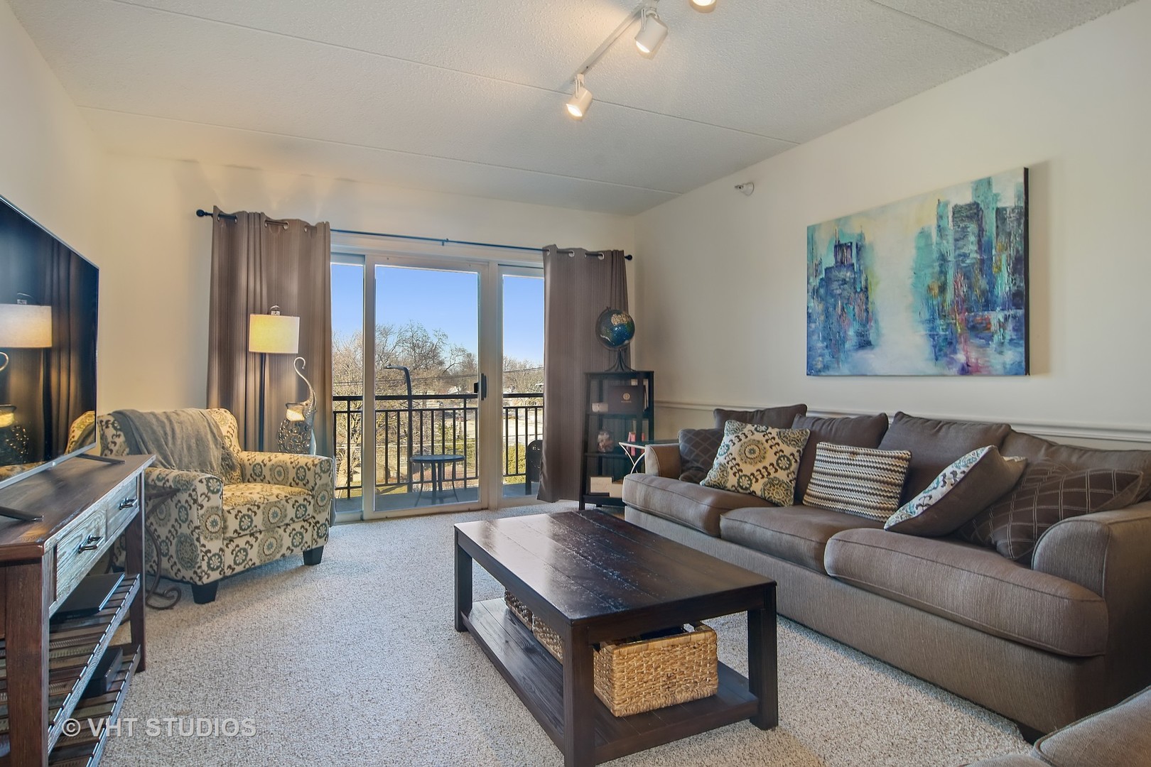 5 West Central Road, Unit 412 Mount Prospect, IL 60056 - Photo 2 of 10 a living room with furniture and a floor to ceiling window
