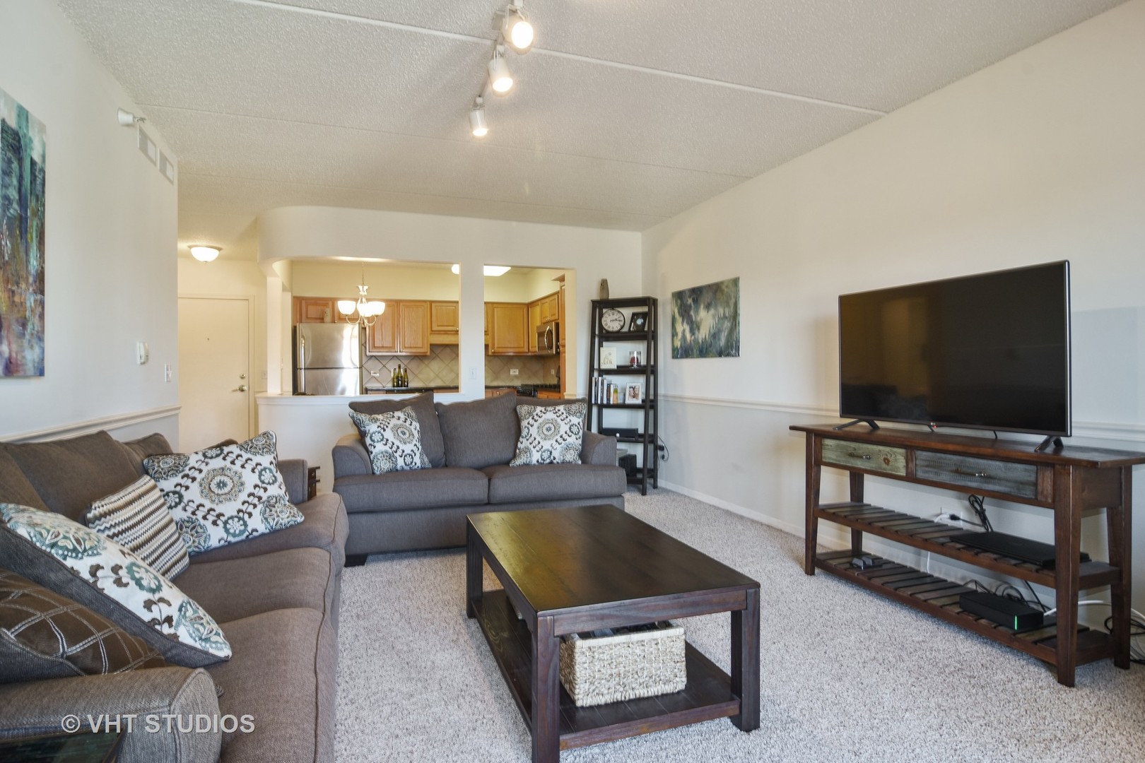 5 West Central Road, Unit 412 Mount Prospect, IL 60056 - Photo 3 of 10 a living room with furniture and a flat screen tv