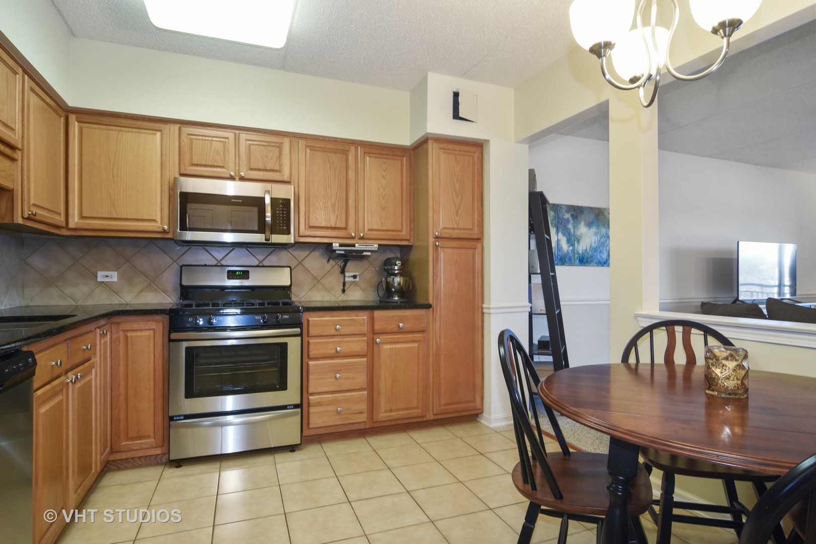 5 West Central Road, Unit 412 Mount Prospect, IL 60056 - Photo 4 of 10 a kitchen with a stove a sink and a refrigerator