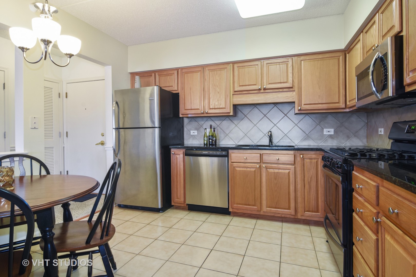 5 West Central Road, Unit 412 Mount Prospect, IL 60056 - Photo 5 of 10 a kitchen with stainless steel appliances granite countertop a refrigerator a sink a stove and white cabinets