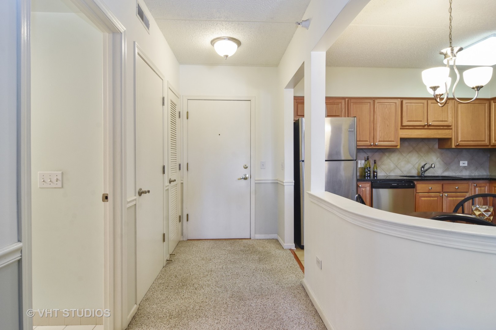 5 West Central Road, Unit 412 Mount Prospect, IL 60056 - Photo 7 of 10 a kitchen with stainless steel appliances granite countertop a refrigerator and a sink