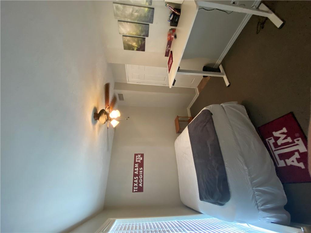 300 Cooner Street College Station, TX 77840 - Photo 4 of 9 a bedroom with a bed and a chandelier