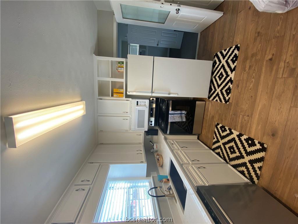 300 Cooner Street College Station, TX 77840 - Photo 8 of 9 a kitchen with a sink a refrigerator and a stove top oven