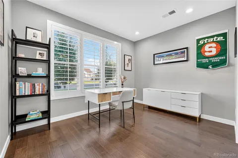 a view of a workspace with furniture and a window
