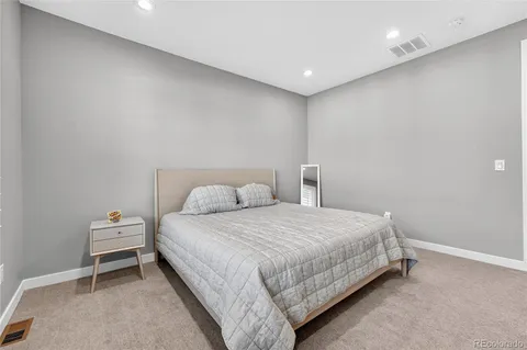 a bedroom with a bed and a chair