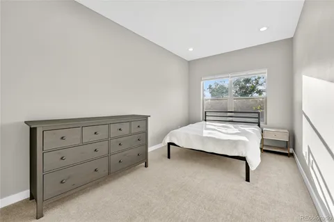 a living room with furniture and a dresser