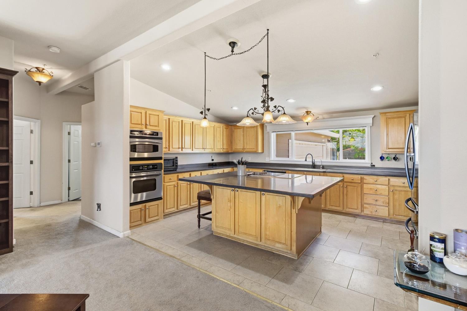 12390 Hobday Road Wilton, CA 95693 - Photo 15 of 92 a large kitchen with kitchen island a stove a sink and a counter top space