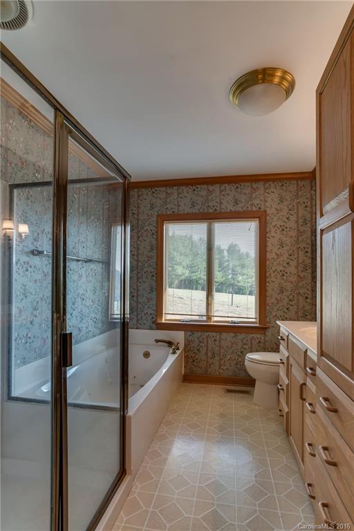 610 Phillips Road Columbus, NC 28722 - Photo 12 of 24 a spacious bathroom with a double vanity sink and a bathtub
