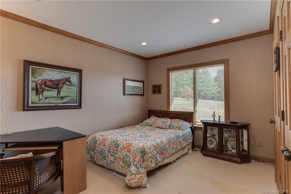 610 Phillips Road Columbus, NC 28722 - Photo 13 of 24 a bedroom with a bed and a window