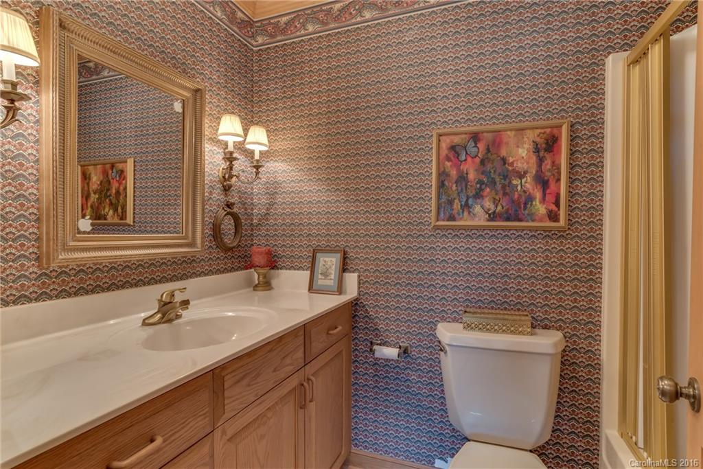 610 Phillips Road Columbus, NC 28722 - Photo 14 of 24 a bathroom with a toilet a sink and mirror