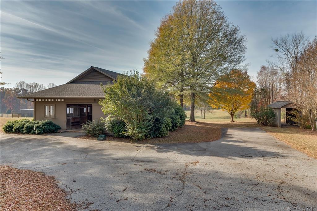 610 Phillips Road Columbus, NC 28722 - Photo 19 of 24 a front view of a house with a yard and a garage