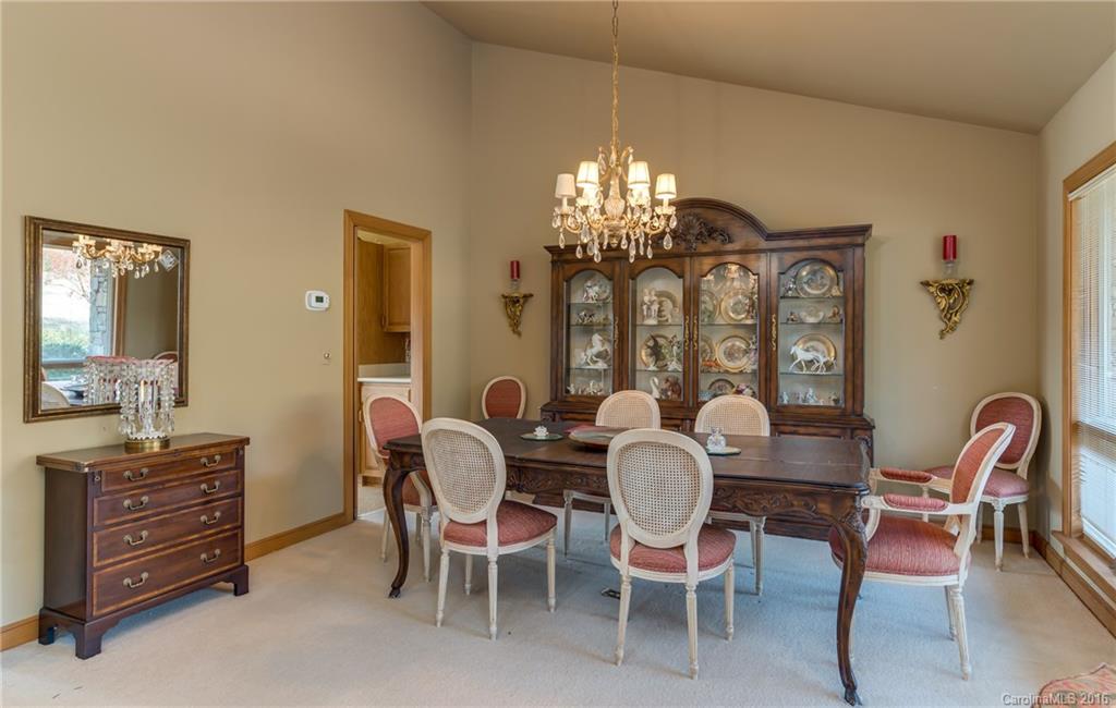 610 Phillips Road Columbus, NC 28722 - Photo 6 of 24 a dining room with furniture a chandelier and a rug