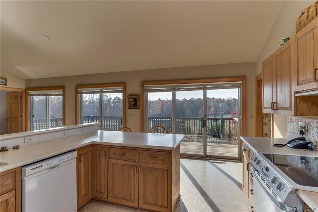 610 Phillips Road Columbus, NC 28722 - Photo 8 of 24 a large kitchen with kitchen island a large window sink and cabinets