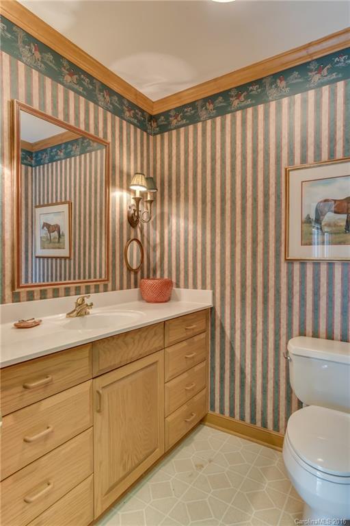 610 Phillips Road Columbus, NC 28722 - Photo 10 of 24 a bathroom with a granite countertop sink and a toilet