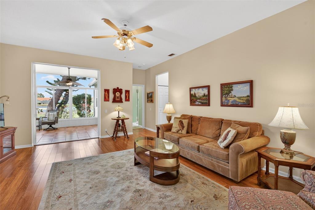4266 Summertree Road Venice, FL 34293 - Photo 10 of 64 a living room with furniture and wooden floor
