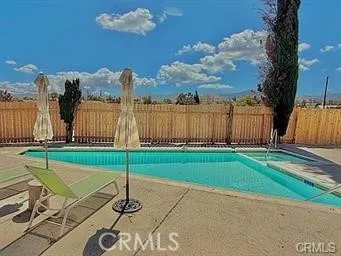 a view of a swimming pool with a lounge chairs