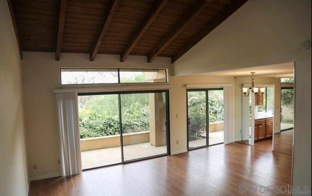 6555 Caminito Scioto La Jolla, CA 92037 - Photo 3 of 12 a view of an empty room with wooden floor and a window