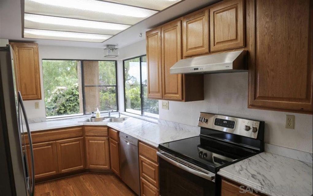 6555 Caminito Scioto La Jolla, CA 92037 - Photo 4 of 12 a kitchen with a sink stove top oven and cabinets