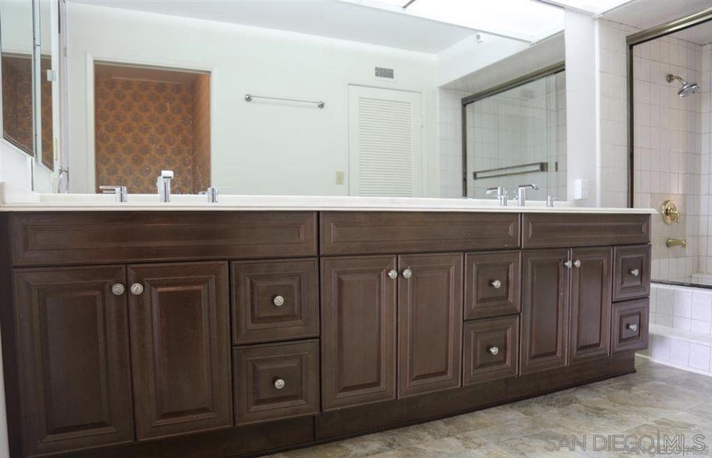 6555 Caminito Scioto La Jolla, CA 92037 - Photo 7 of 12 a bathroom with a sink and a mirror