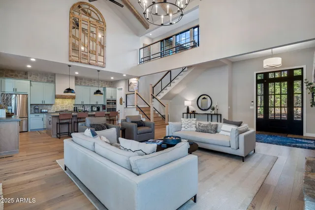 a living room with furniture and kitchen view