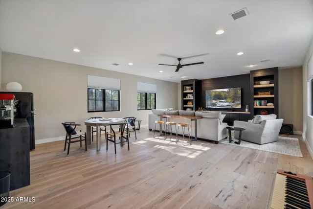 an aerial view of residential houses with outdoor space and trees