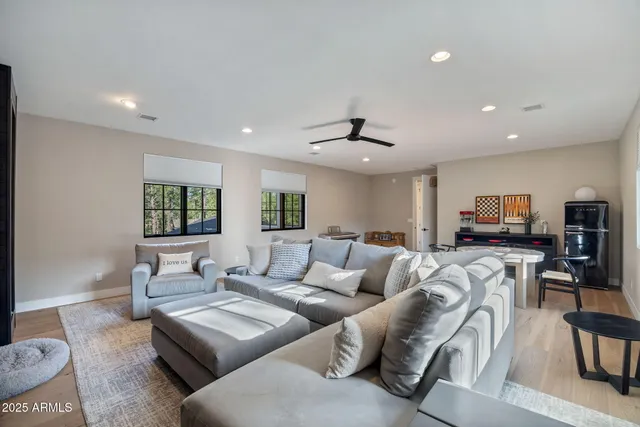 an aerial view of residential houses with outdoor space and trees