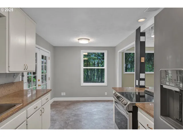 a kitchen with granite countertop a sink and a stove