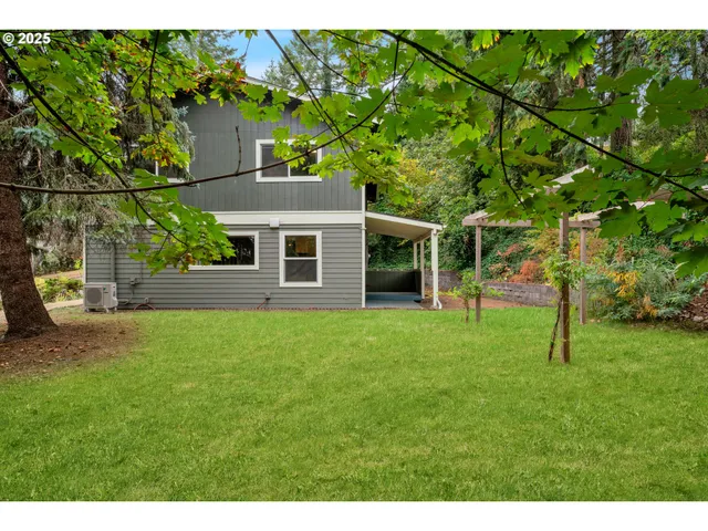 a view of a house with a backyard