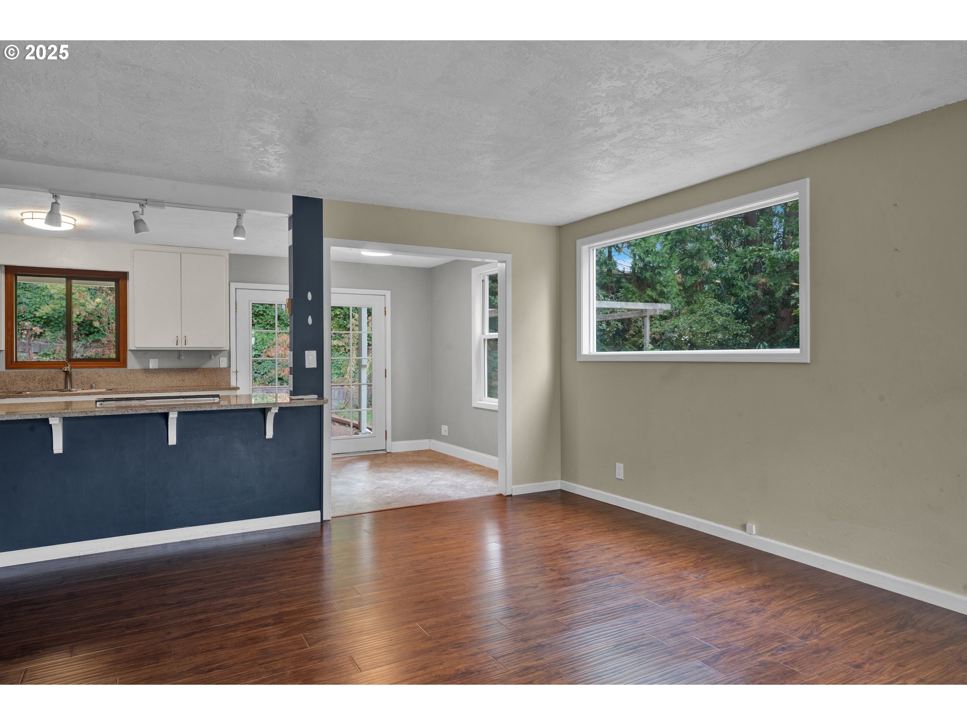 2850 Garfield Street Eugene, OR 97405 - Photo 6 of 46 a view of an empty room with wooden floor and a window
