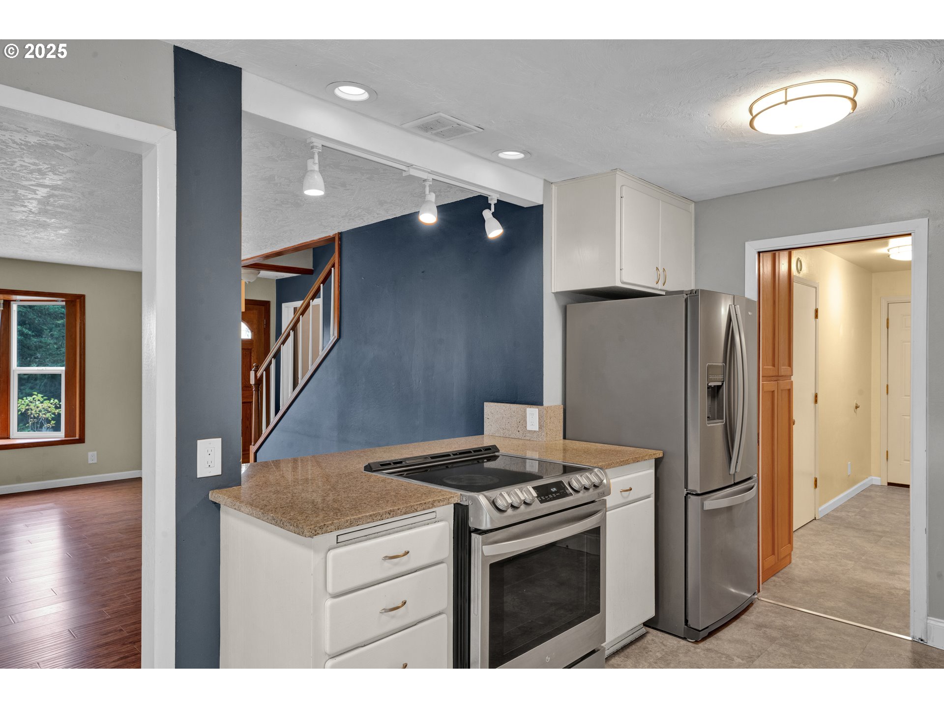 2850 Garfield Street Eugene, OR 97405 - Photo 8 of 46 a kitchen with stainless steel appliances granite countertop a refrigerator a stove and a sink with wooden floor