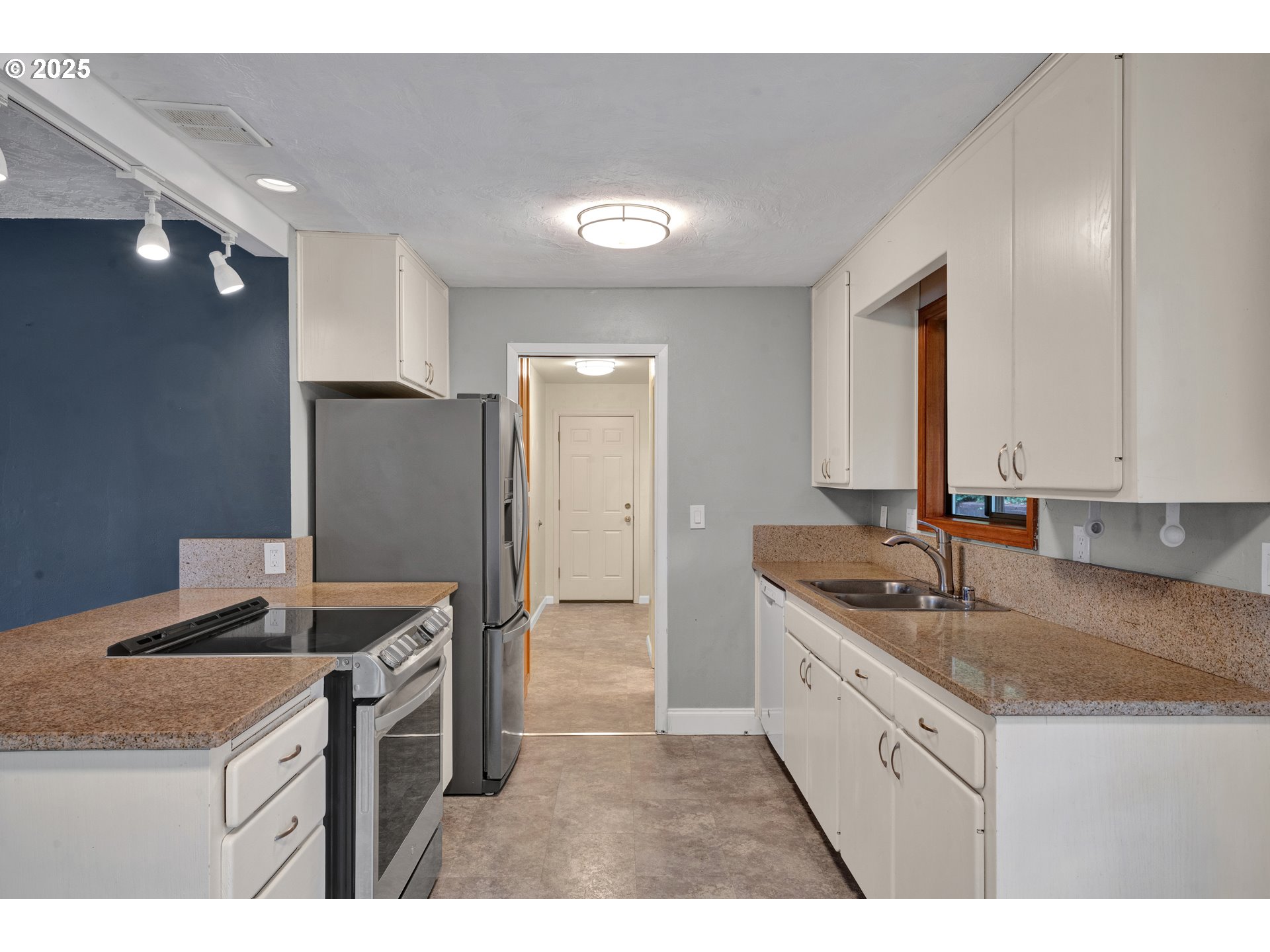 2850 Garfield Street Eugene, OR 97405 - Photo 9 of 46 a kitchen with granite countertop kitchen island stainless steel appliances a sink stove and refrigerator