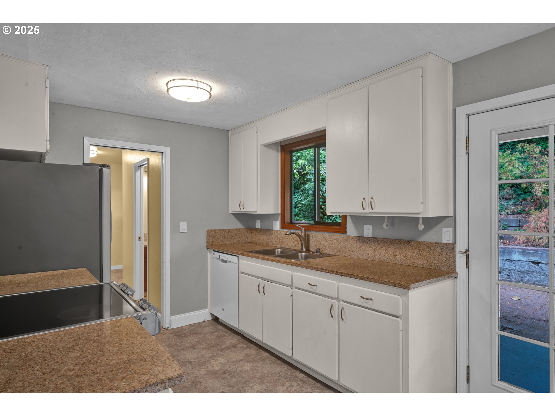 2850 Garfield Street Eugene, OR 97405 - Photo 10 of 46 a kitchen with a sink cabinets and window